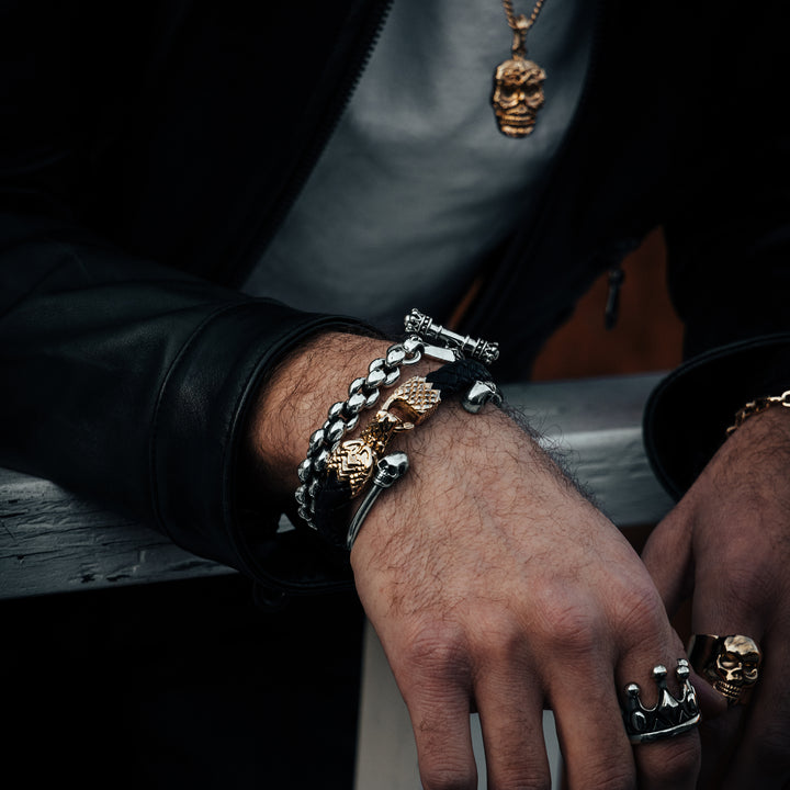 Product shot of 10K Gold Carved Baroque Skull Pendant with other jewelry