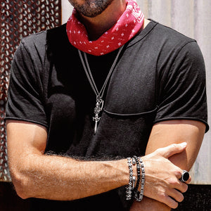 man in black shirt with sterling silver jewelry and red bandana