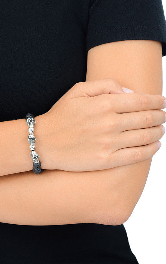 8mm Lava Rock Bead Bracelet w/ 3 Skulls and 2 Silver Beads on model's wrist