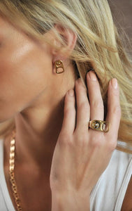 woman wearing king baby 18k gold earrings
