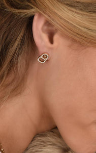 woman wearing king baby gold earrings with diamonds